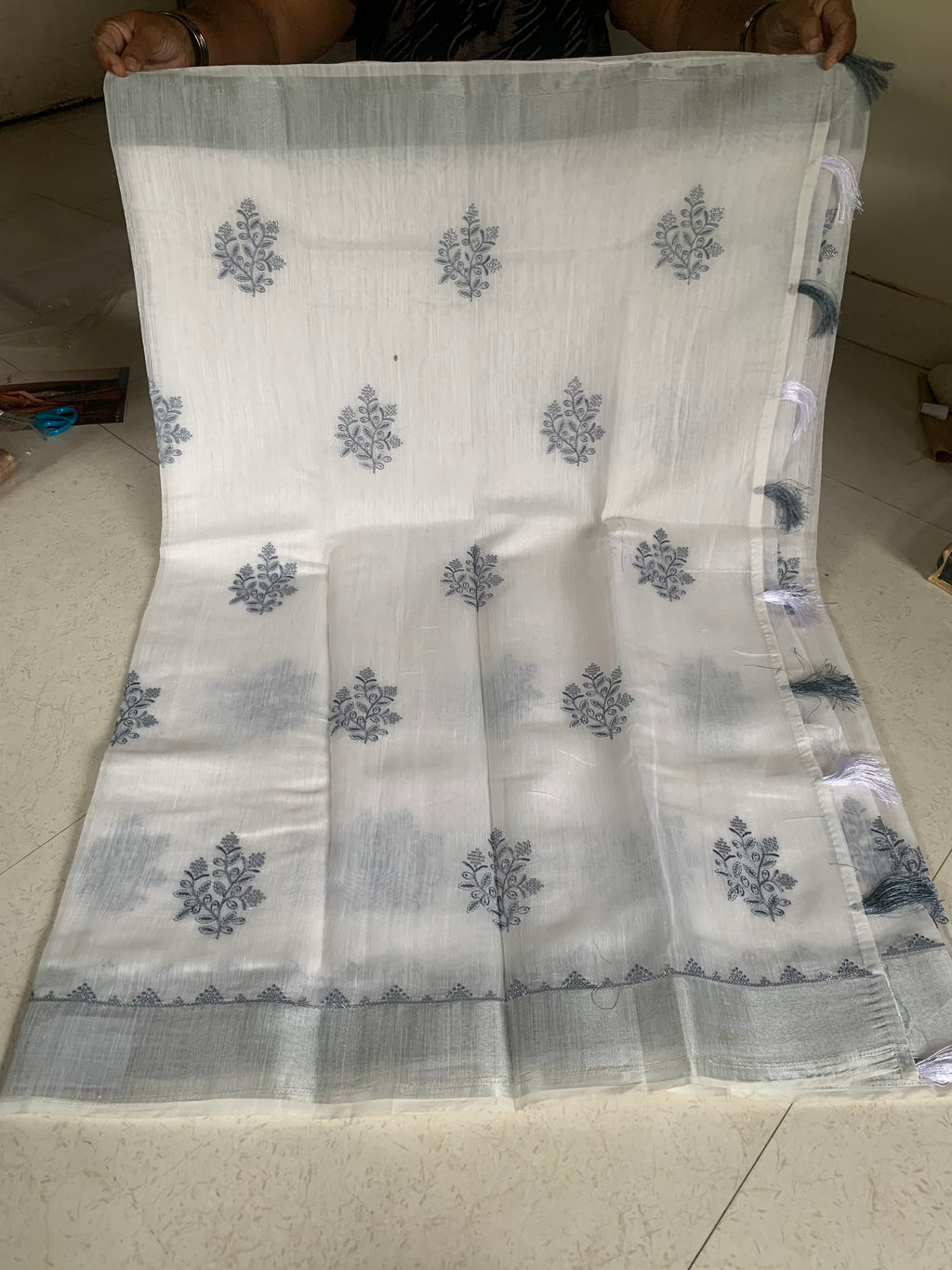 White Linen Saree with Silver-Grey Botanical Embroidery & Tassel Border