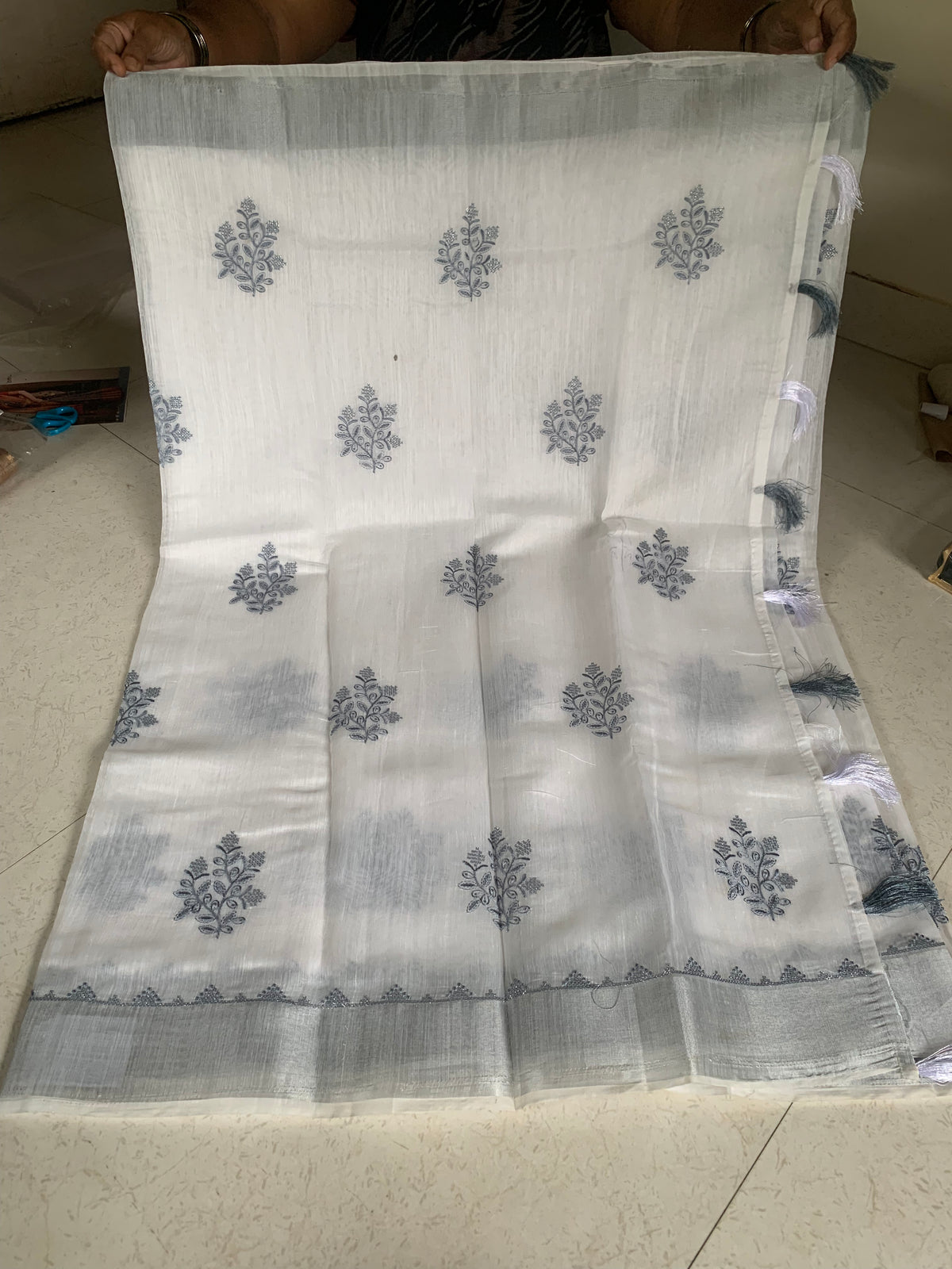 White Linen Saree with Silver-Grey Botanical Embroidery & Tassel Border