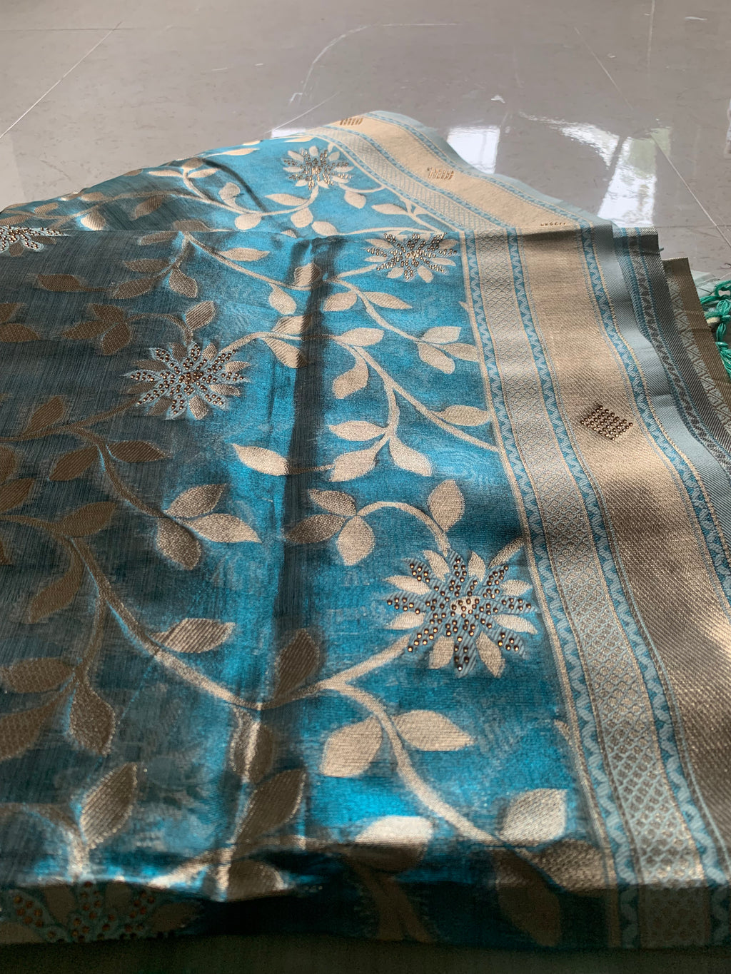 Teal Organza designer Saree with Gold Botanical Vines, Embellished Flowers & Tassels