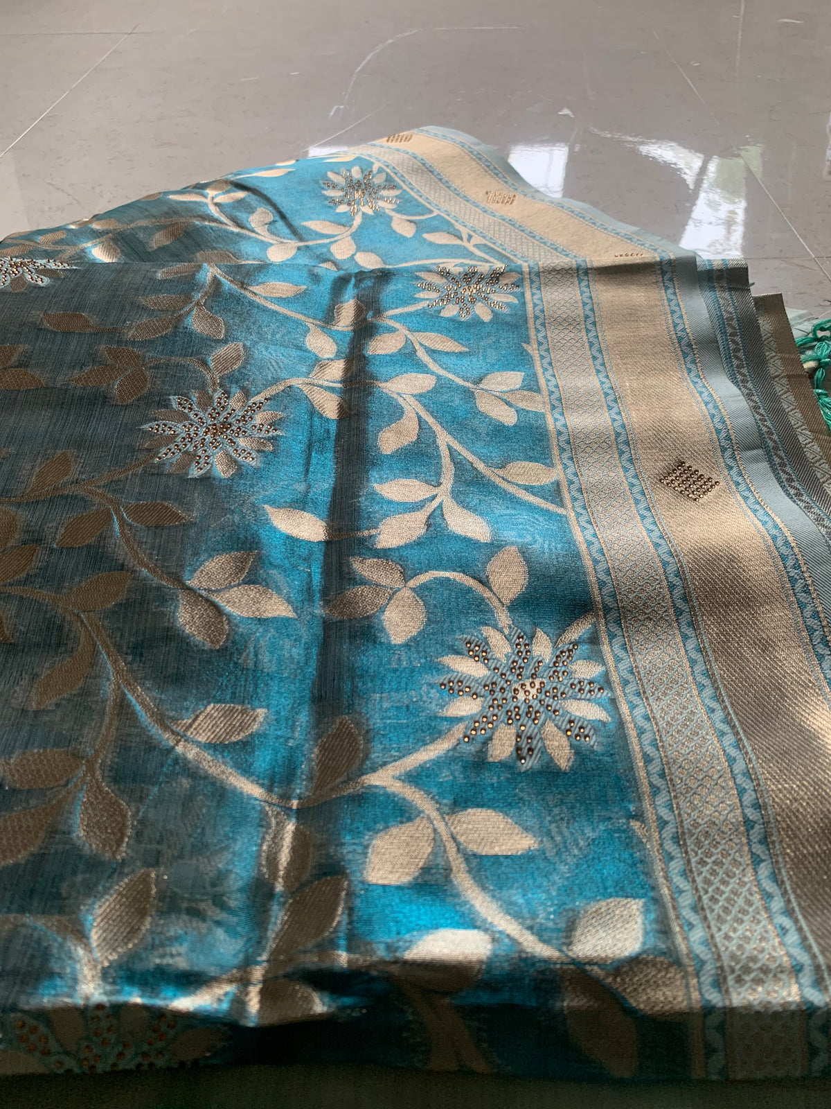 Teal Organza designer Saree with Gold Botanical Vines, Embellished Flowers & Tassels